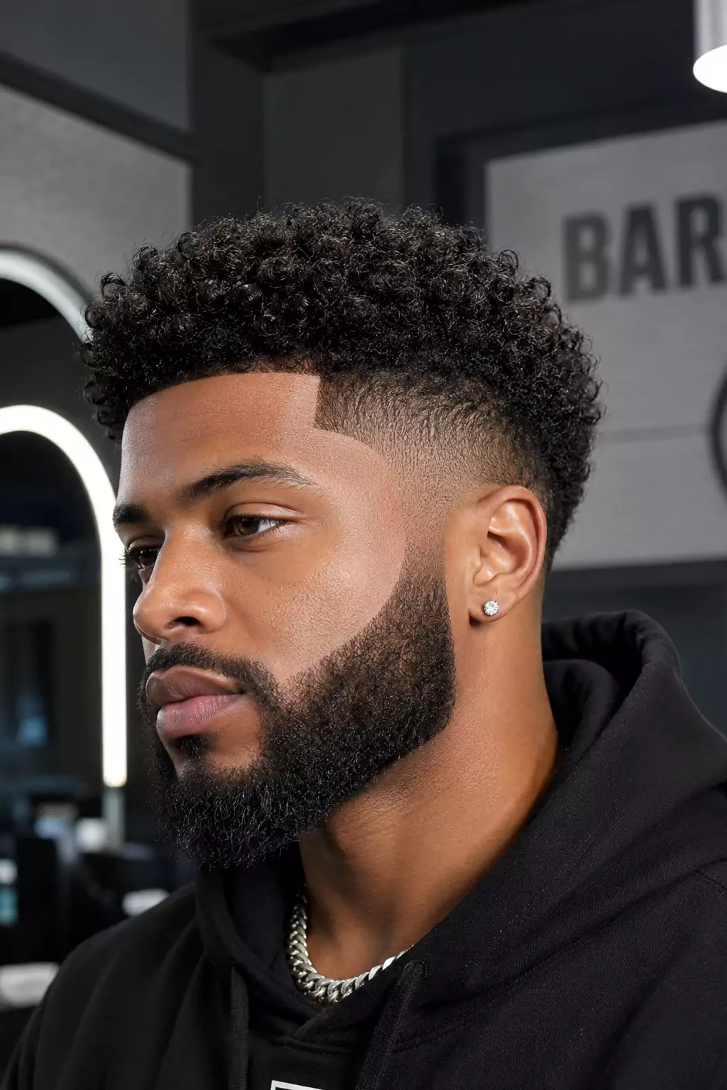 Curly fade hairstyle for Black men with defined texture and beard