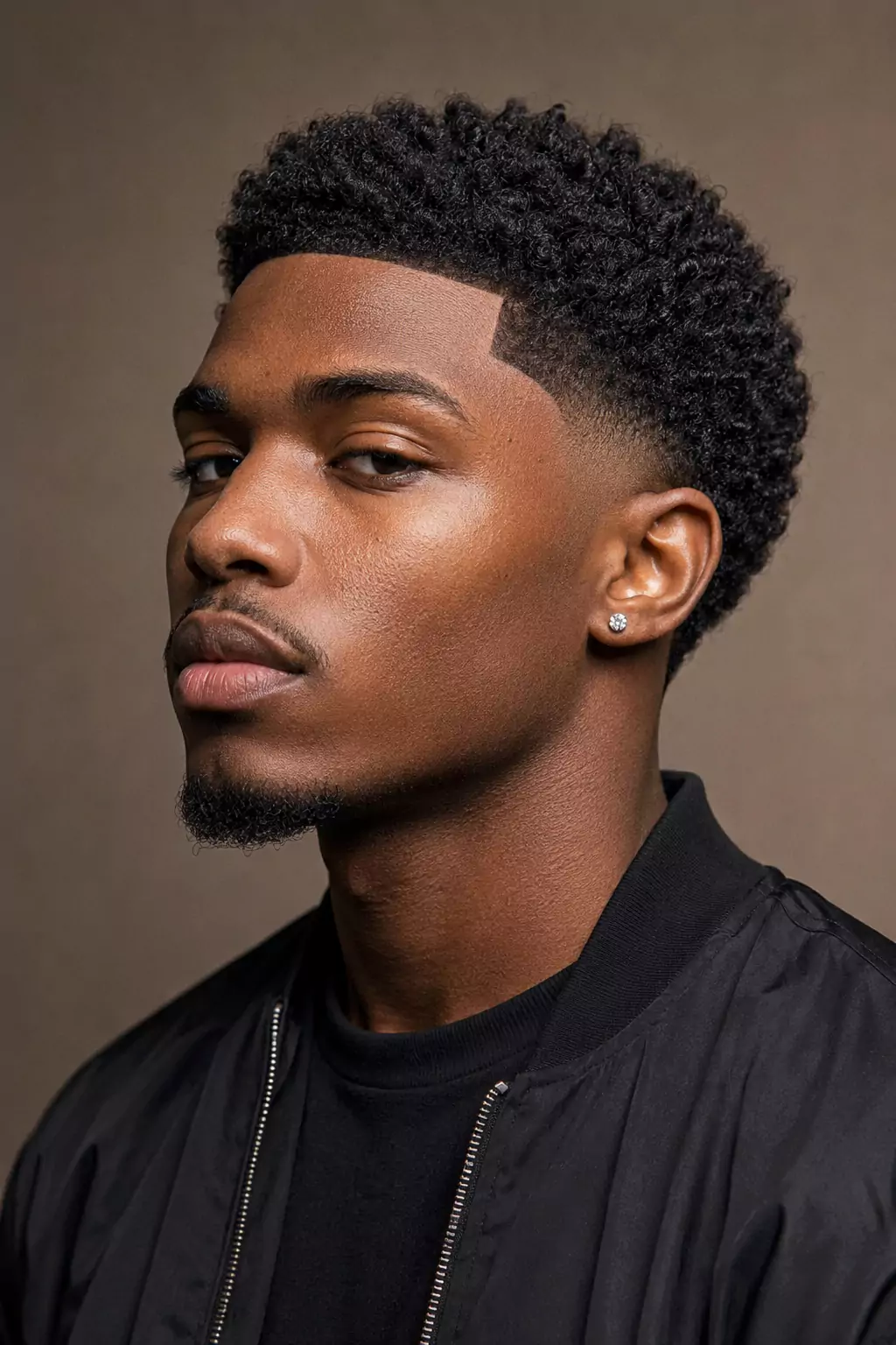 Low taper fade haircut for Black men with curly textured top and clean line up