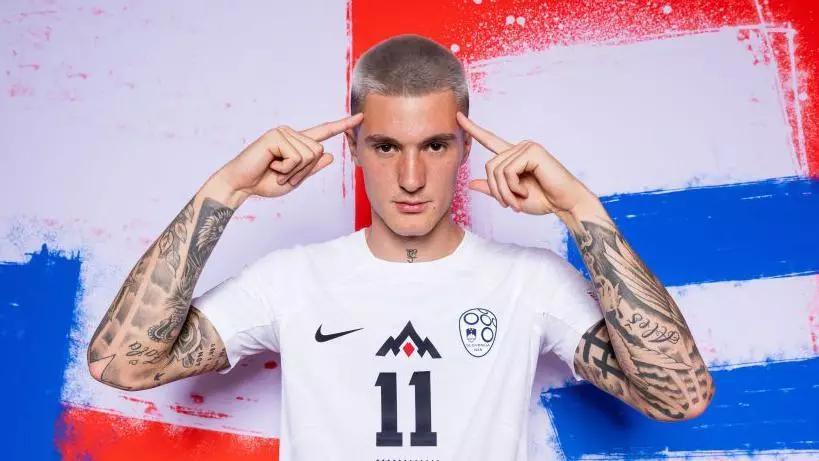 Close-up of platinum bleached buzz cut at #2–#3 length, even cool-toned blonde, uniform stubble texture, healthy scalp finish, high-contrast lighting that highlights the clean buzz cut silhouette