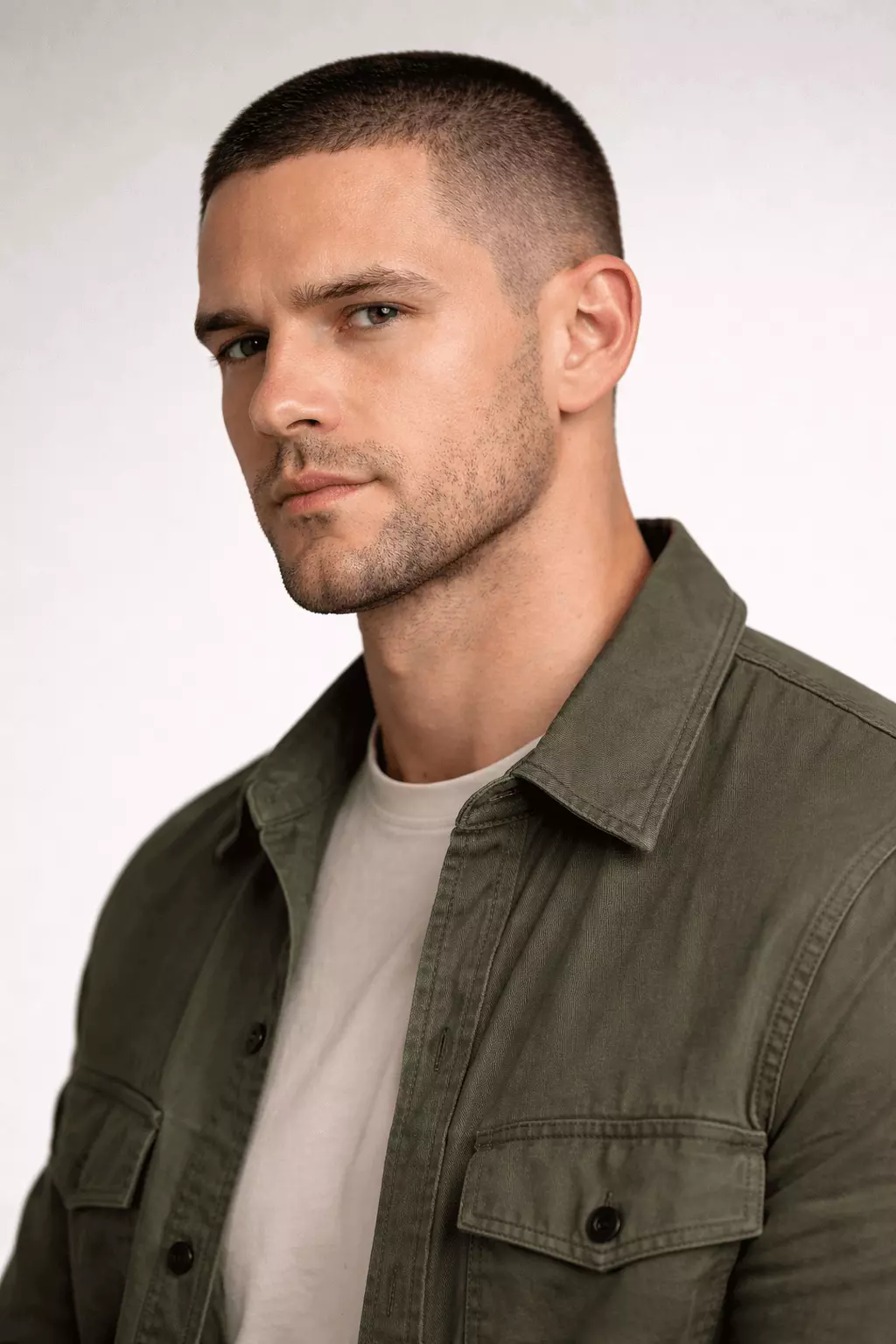 Man with #1 buzz cut and short boxed beard, balanced proportions, masculine style.