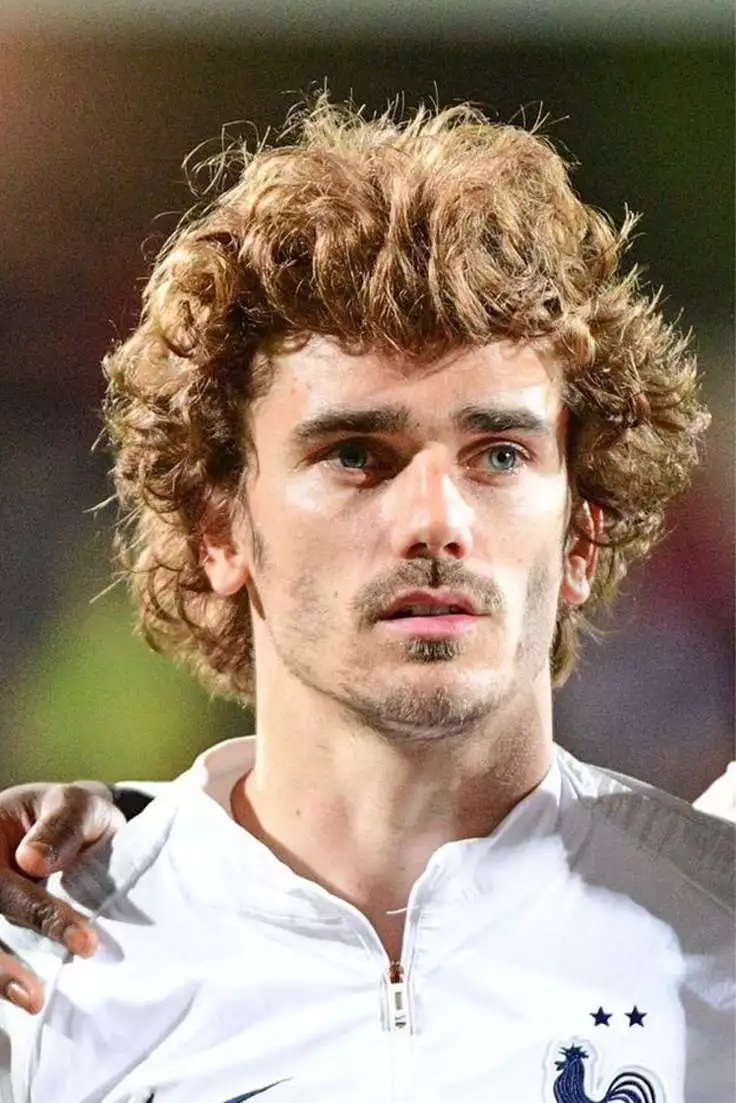 Antoine Griezmann long textured footballer hairstyle