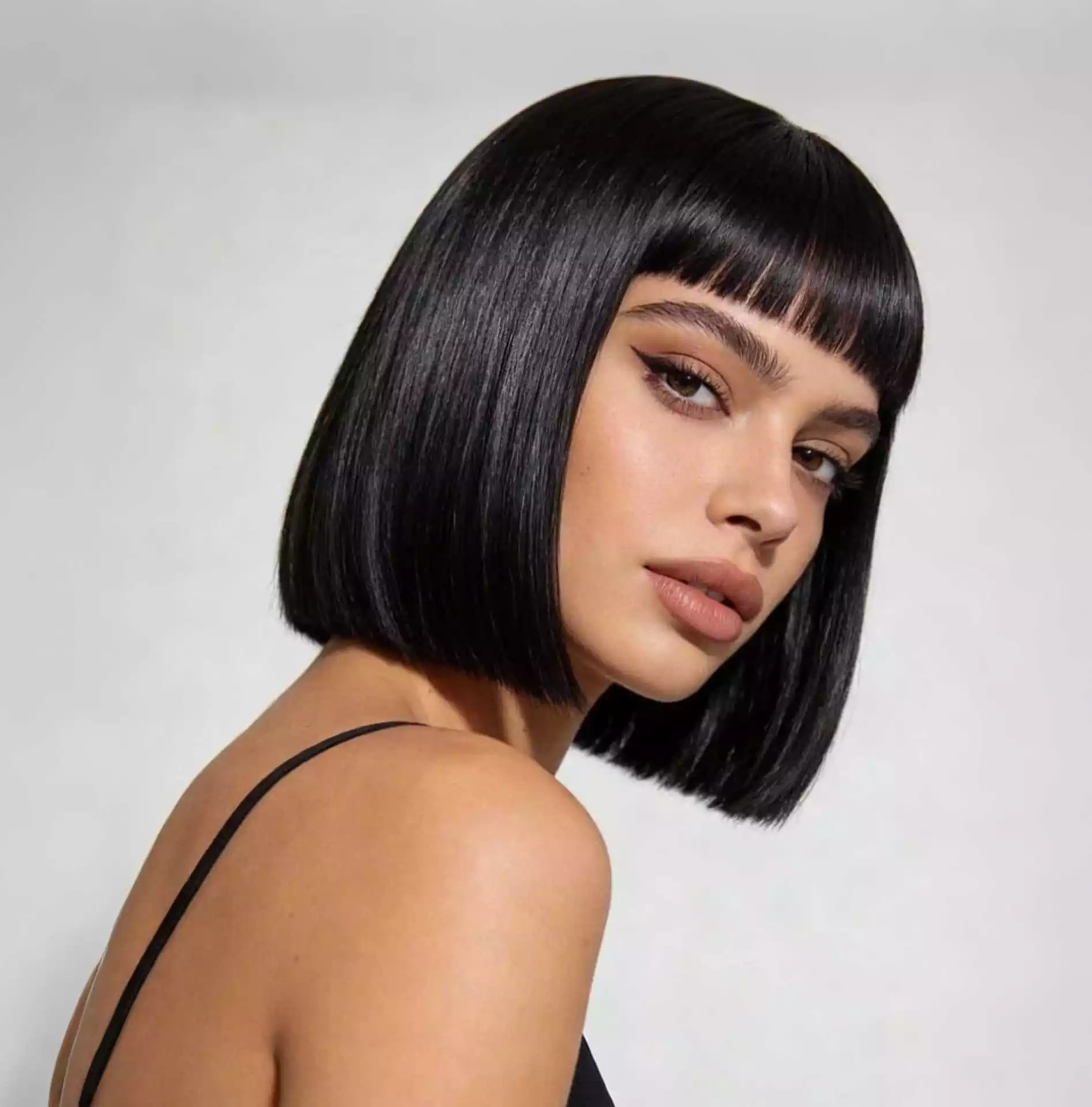Blunt bob haircut with full fringe bangs and crisp straight-across ends