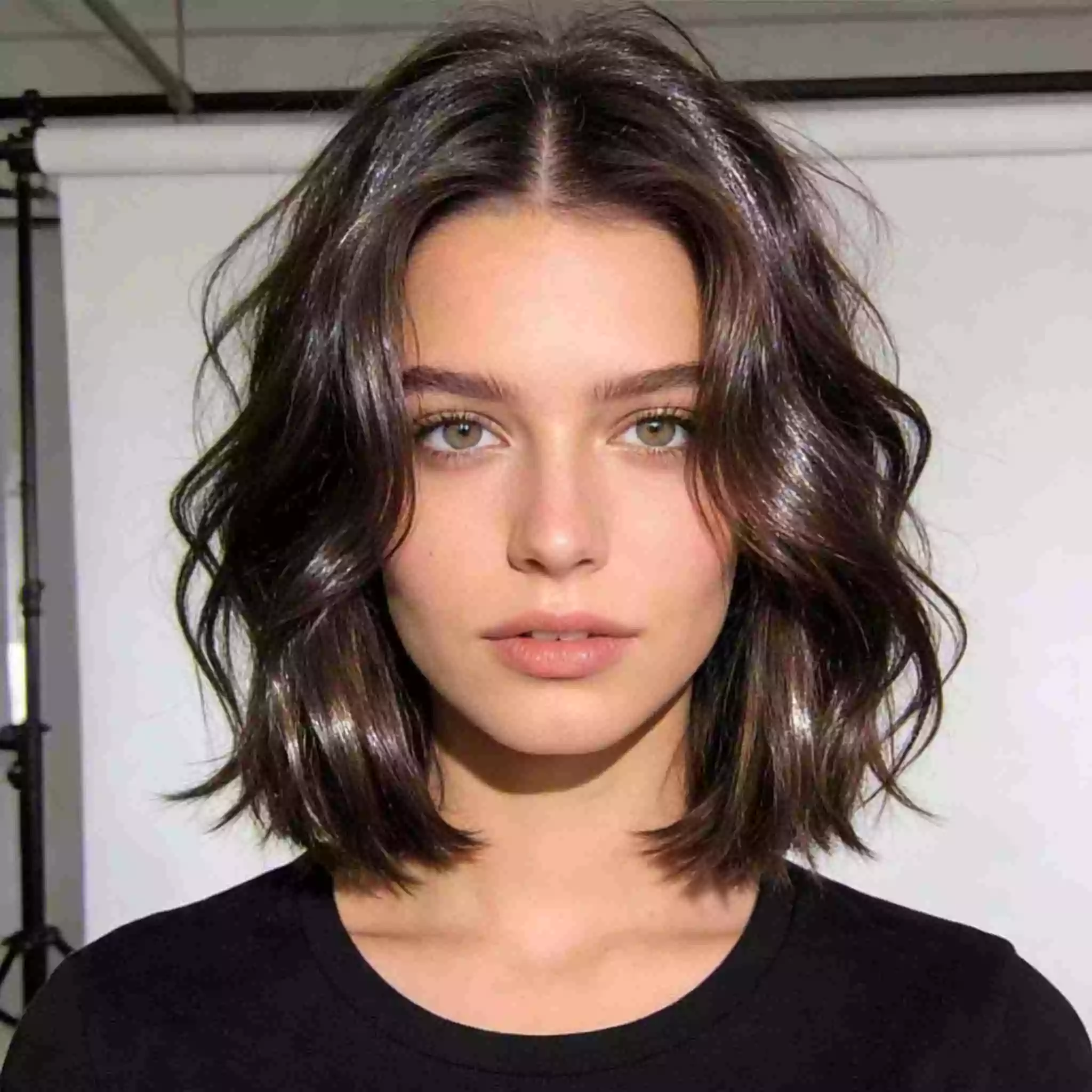 Medium layered bob haircut, front view, soft face-framing layers and movement