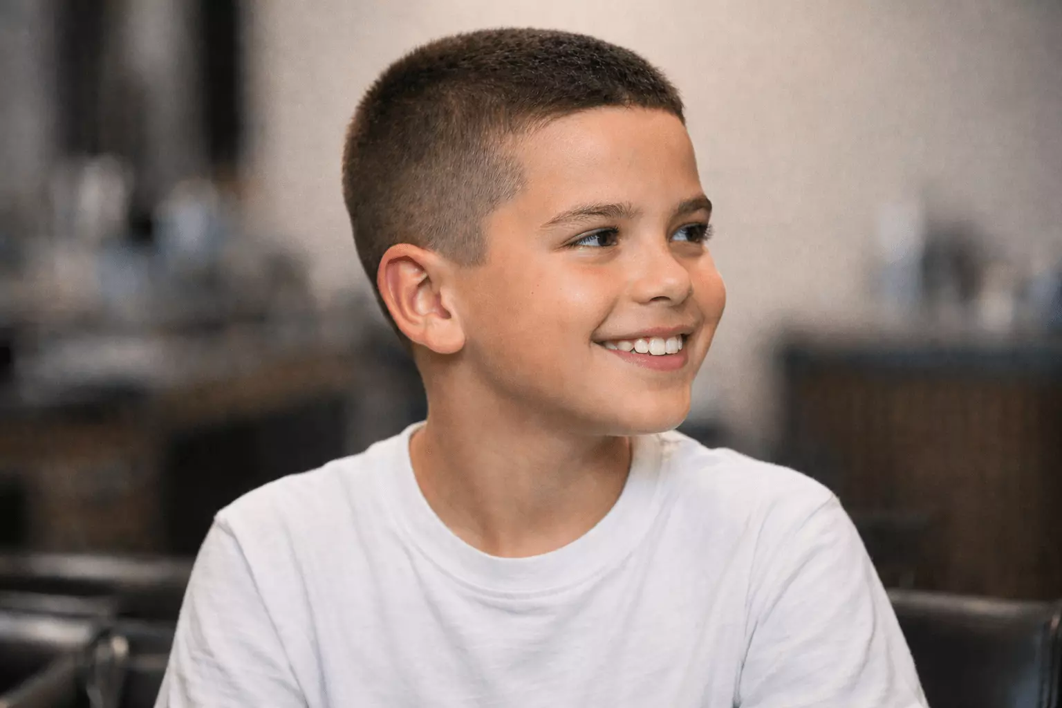 Classic boys buzz cut with even clipper length and natural hairline; clean and simple short haircut example