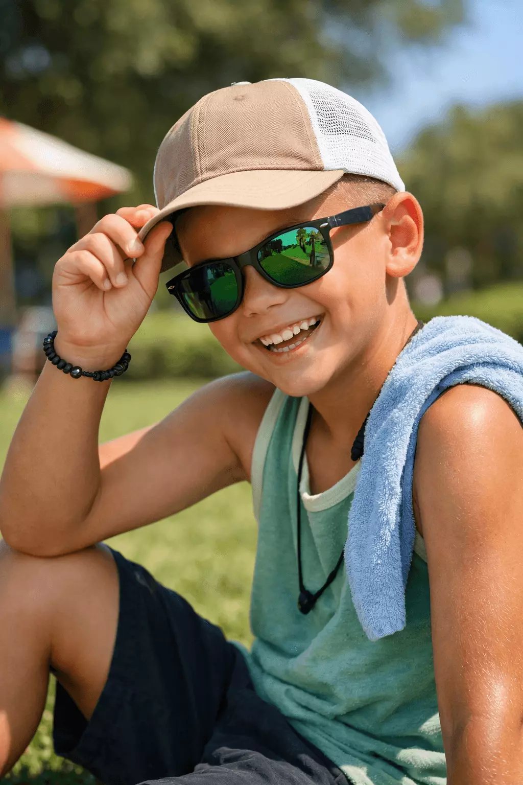 Summer scalp care example for boys with very short buzz cut wearing hat outdoors