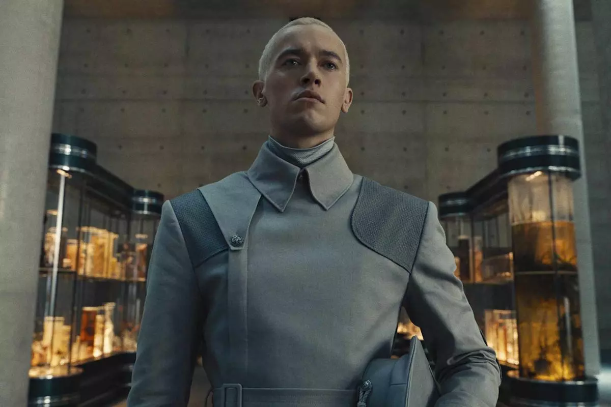 Tom Blyth Coriolanus Snow buzz cut front portrait close-cropped burr cut uniform length scalp slightly visible cinematic lighting Peacekeeper transformation