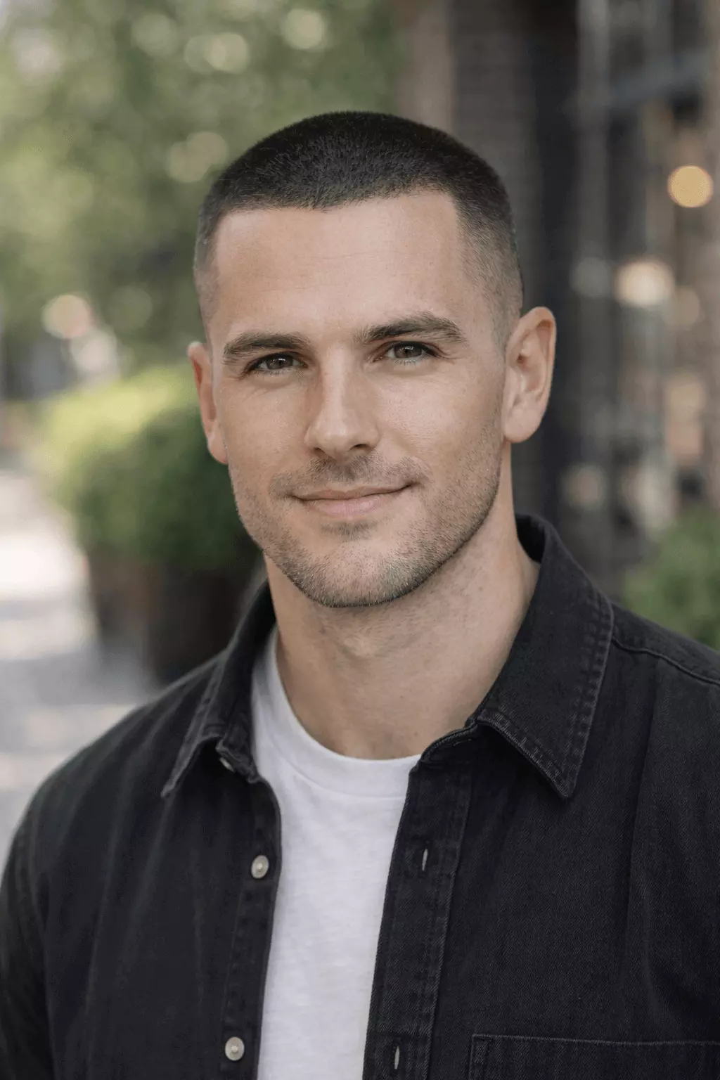 Person with diamond or heart face shape wearing soft fade #3 buzz cut