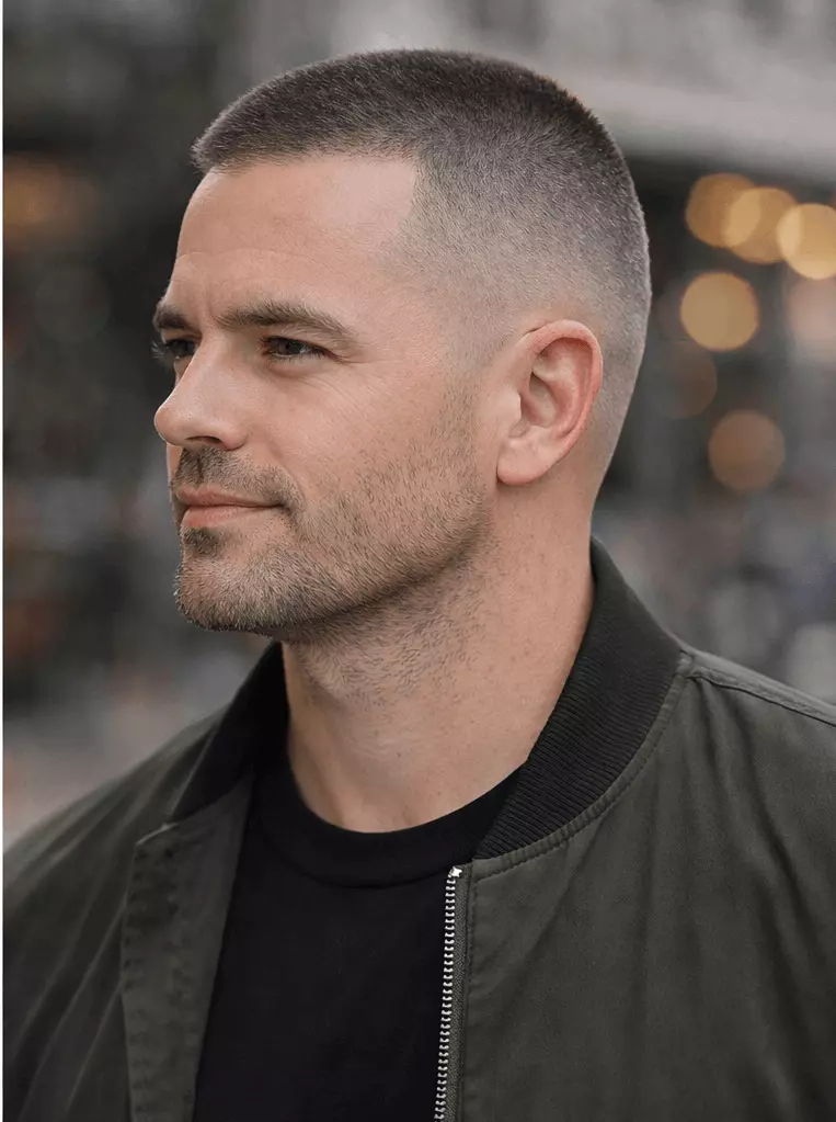 Man with #1 buzz cut and mid fade, sharp transitions, strong jawline definition.