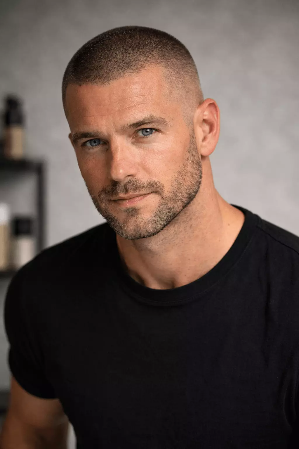 Man with classic uniform #2 buzz cut, 6mm length, natural masculine appearance, studio portrait.