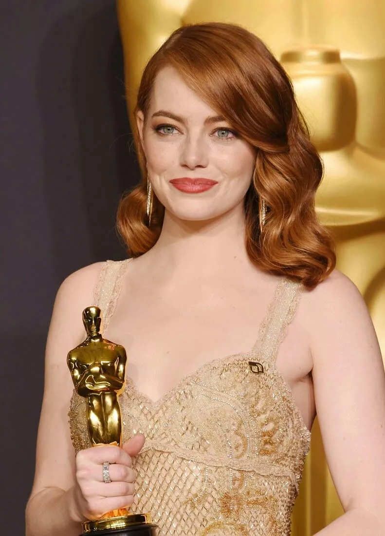 Emma Stone showcasing signature copper red hair at an awards show