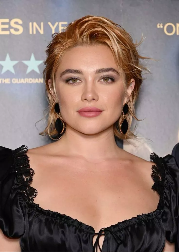 Florence Pugh with textured copper hair styled in a tousled, edgy pixie cut