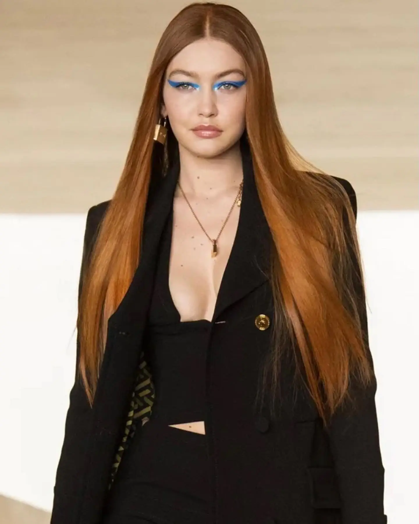 Gigi Hadid rocking warm copper blonde hair with subtle highlights during fashion week