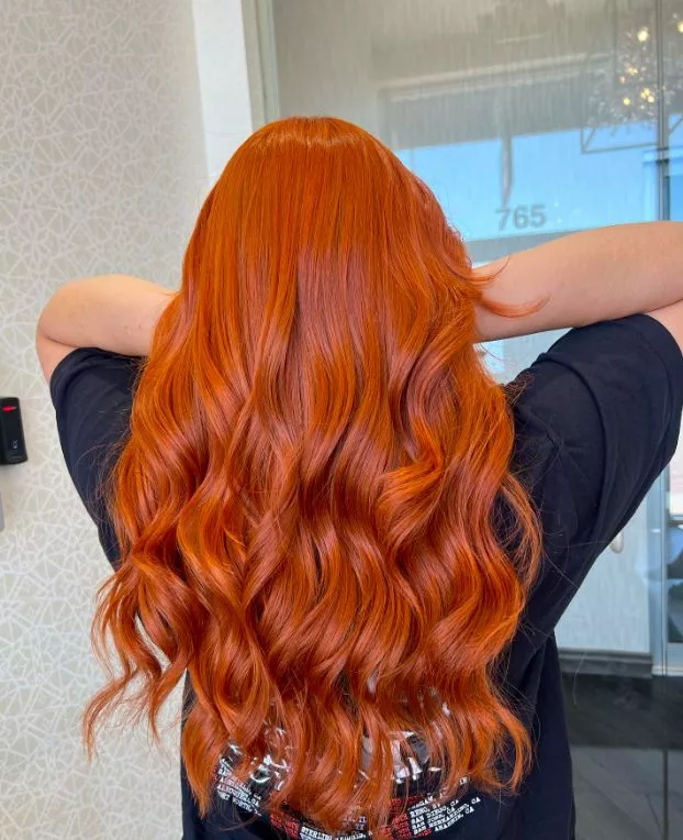 Burnt orange copper lob haircut with vivid fiery tones and blunt ends for a bold modern copper hair style