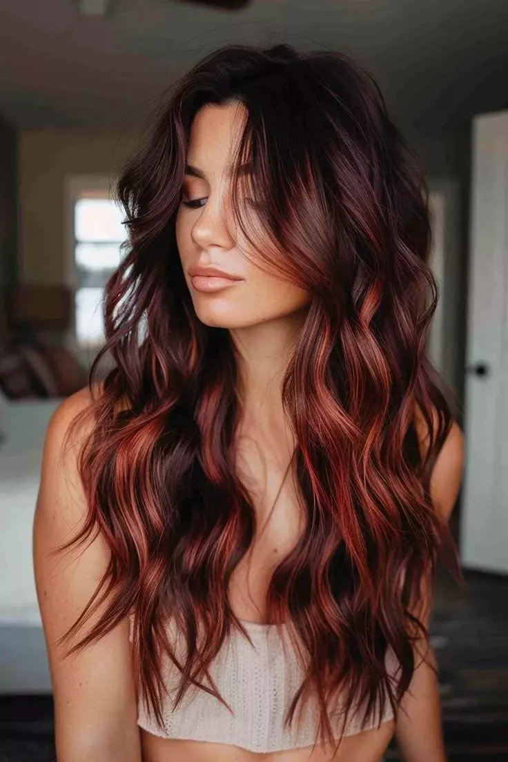 Dark copper ombre hair transitioning from deep brown roots to vibrant copper ends with soft waves