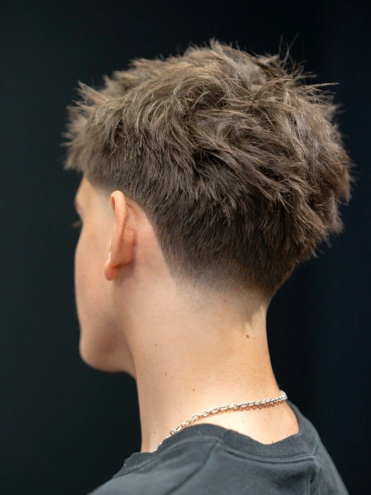 Taper fade haircut with a subtle transition around the neckline and sideburns.