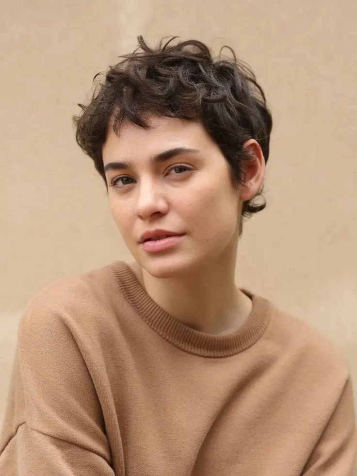 Short curly pixie hairstyle, tapered nape and spiral crown