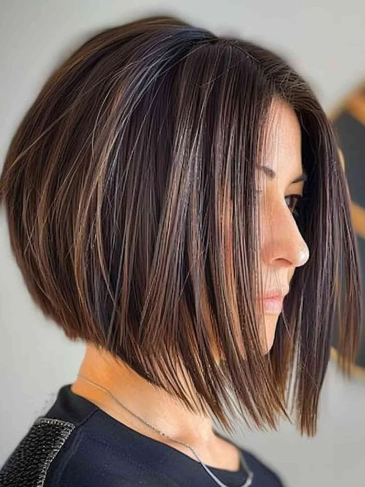 Angled bob haircut: longer front strands slimming round face shape