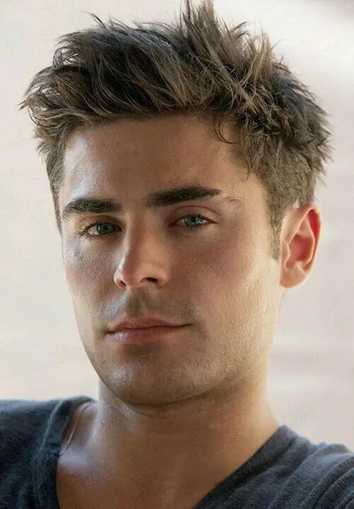 2025 Warrior Cut variations collage: Classic low fade, Messy tousled top, and Blowout voluminous styles